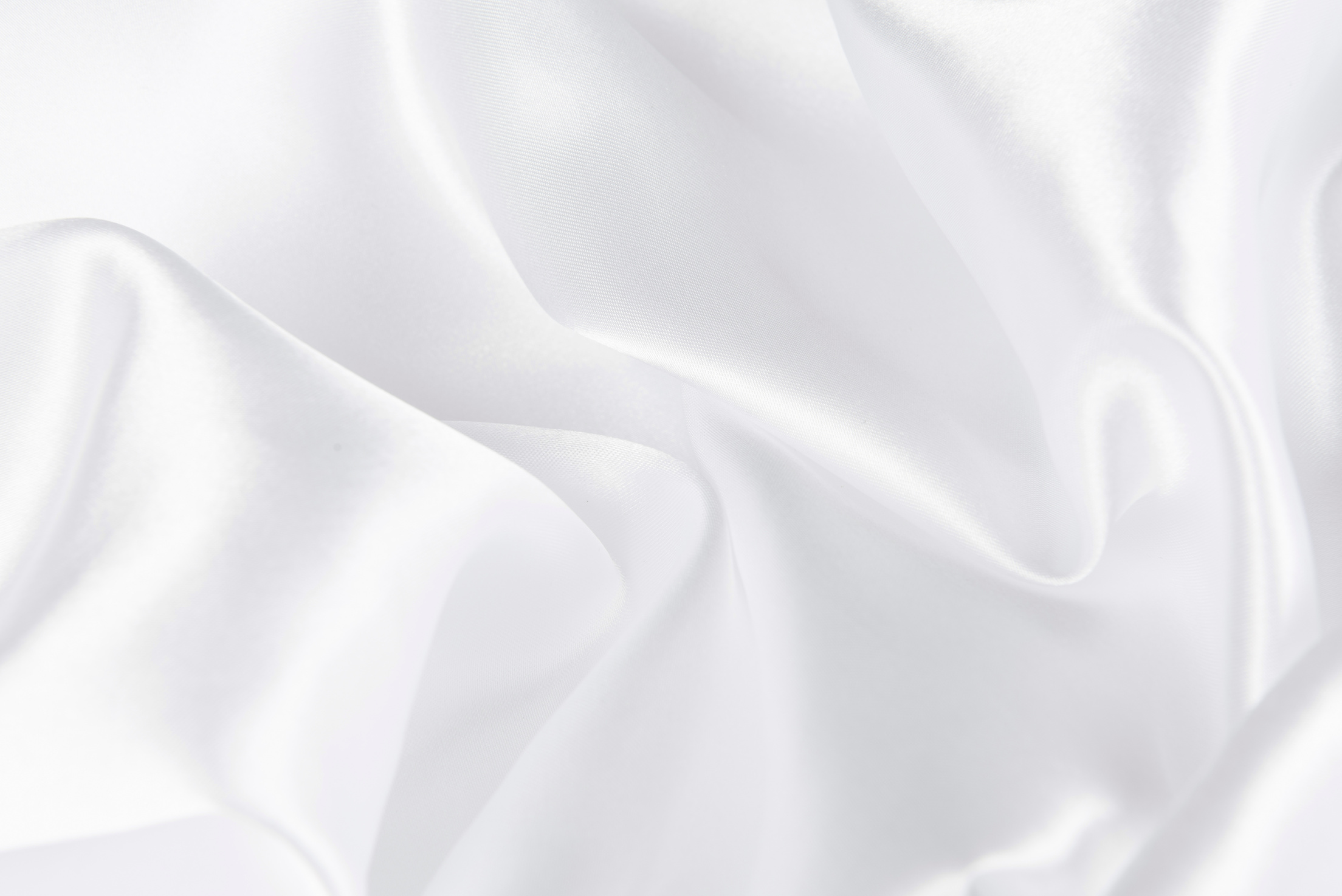 Abstract white fabric texture background. Cloth soft wave. Creases of satin, silk, and cotton.